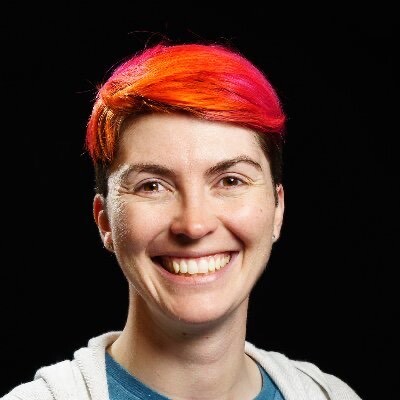Smiling woman with short bright red hair