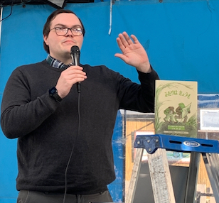 Man holding a microphone while speaking