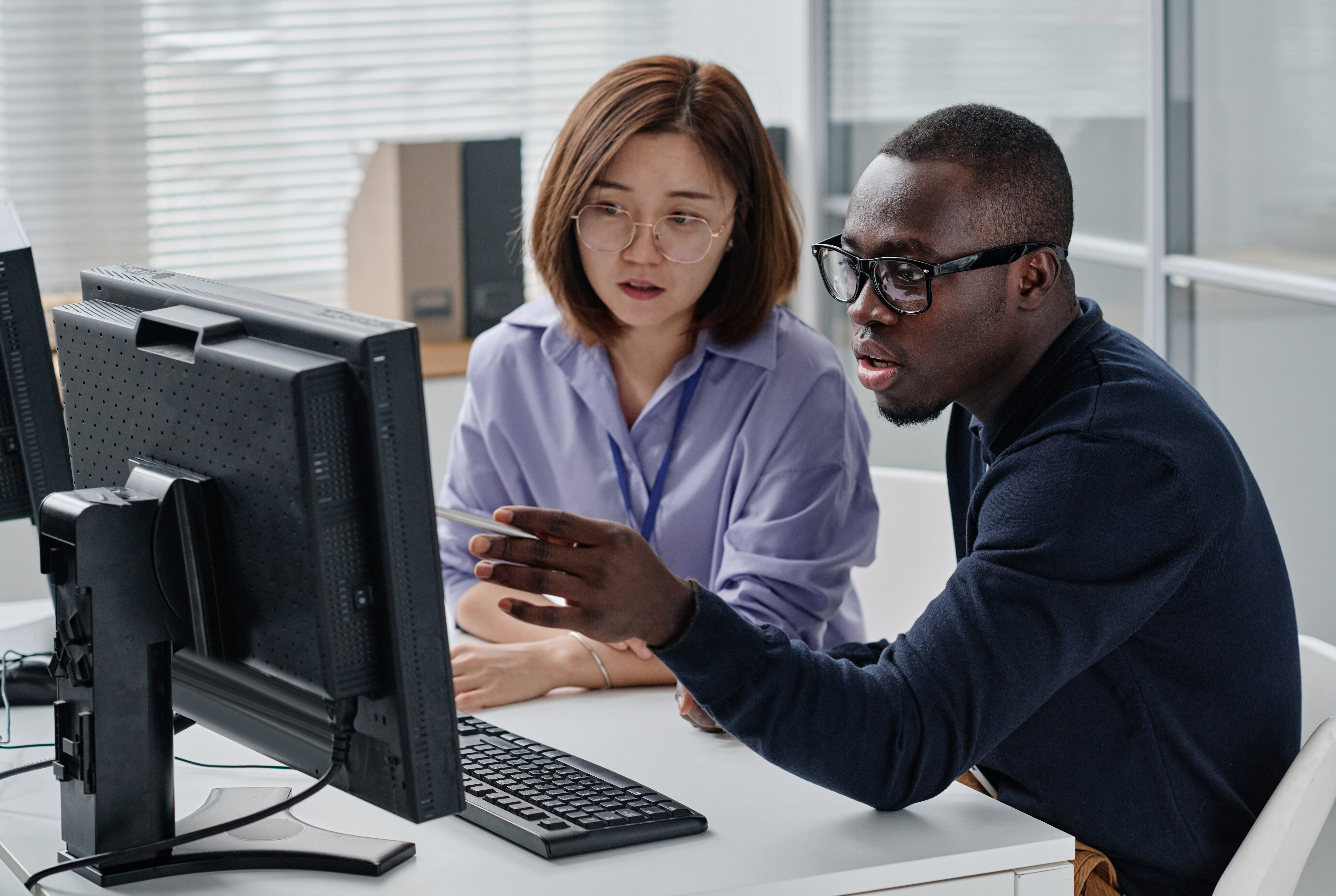 Man and woman reviewing security data on a screen, demonstrating how Crowdalert helps detect and address security threats before they escalate