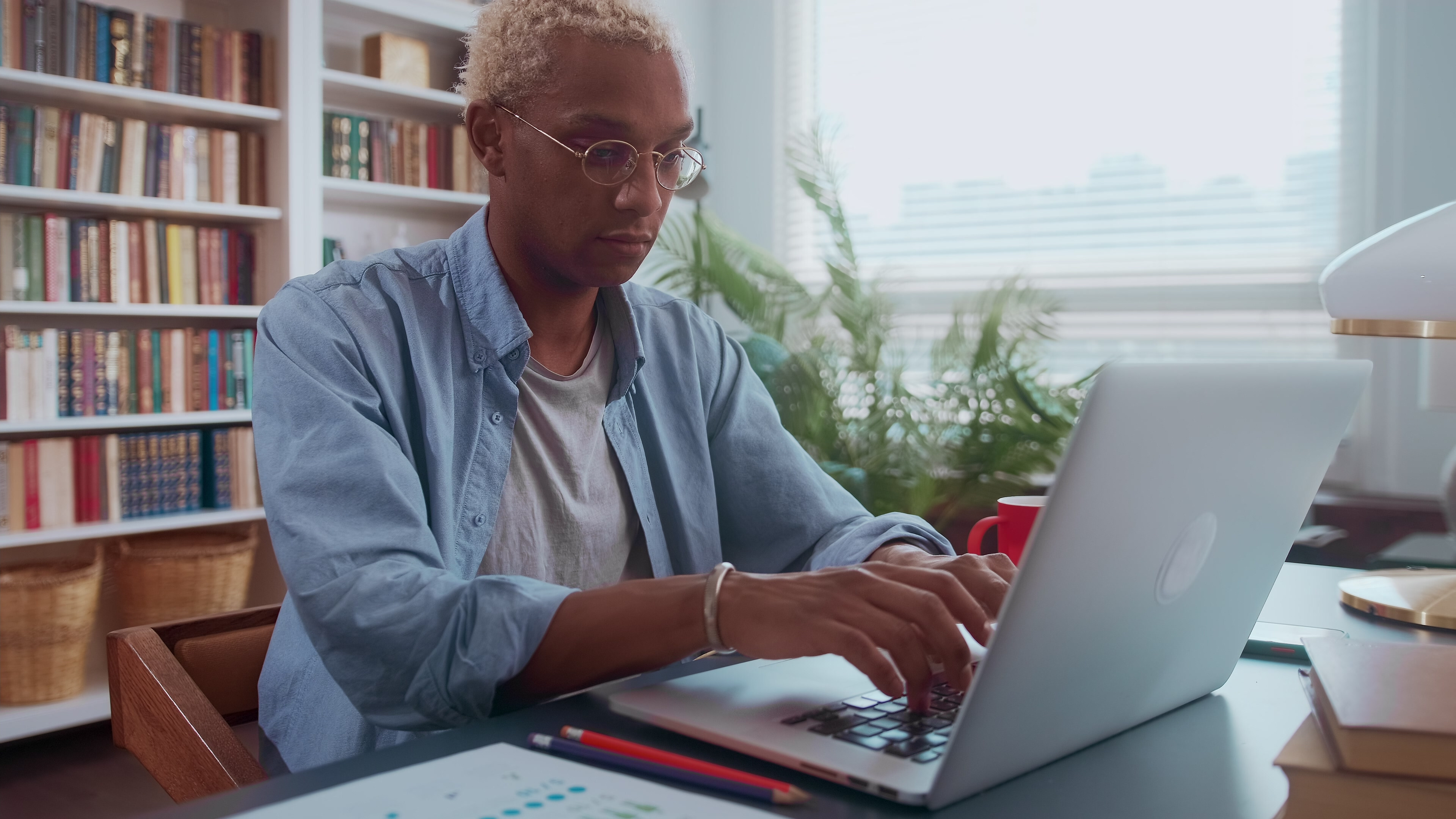 Man focused on his computer, demonstrating how Crowdalert's Identity Graph simplifies real-time user activity analysis for effective security alerts