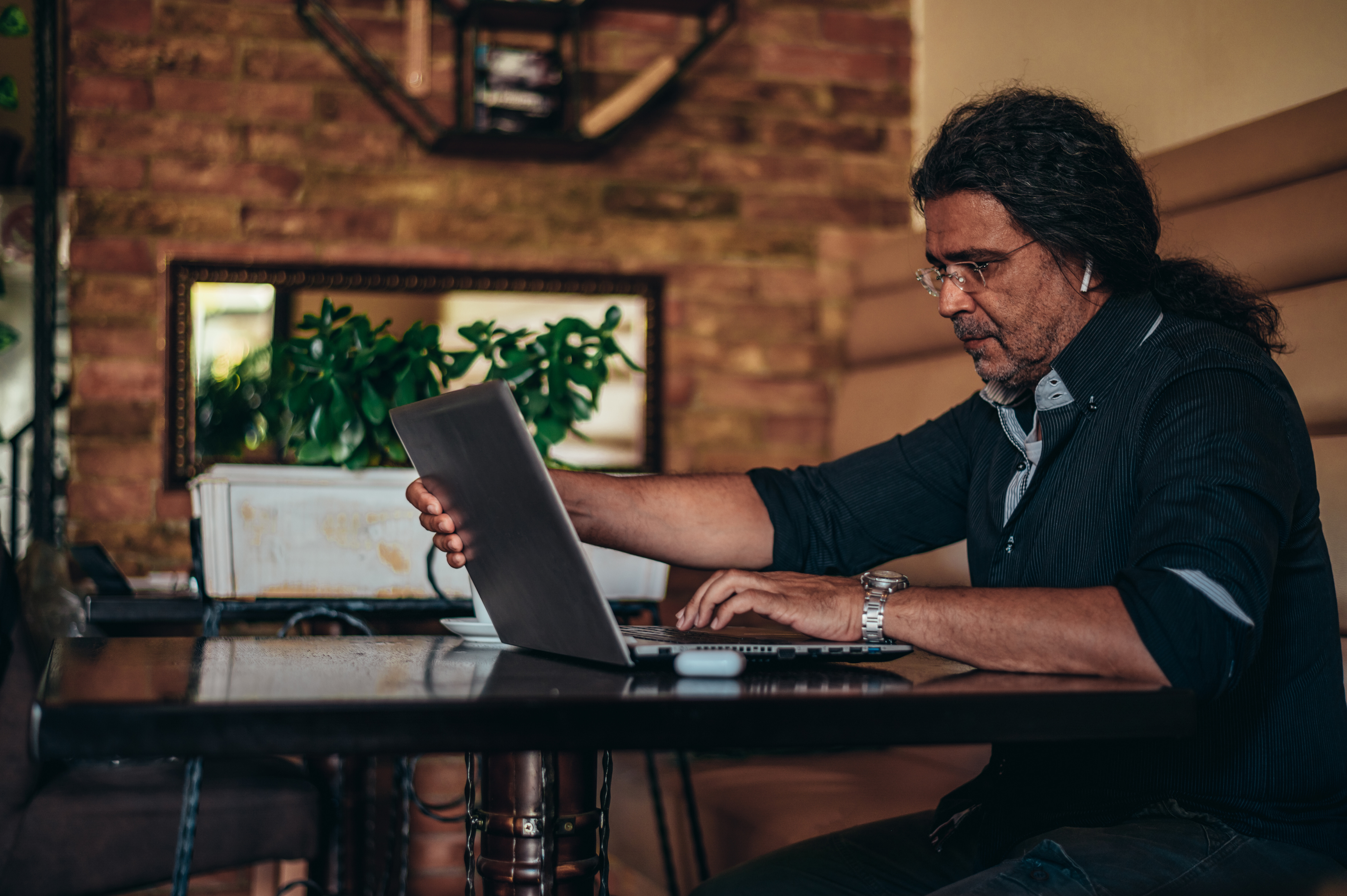 Man focused on his laptop, demonstrating how Crowdalert helps reduce excessive security alerts