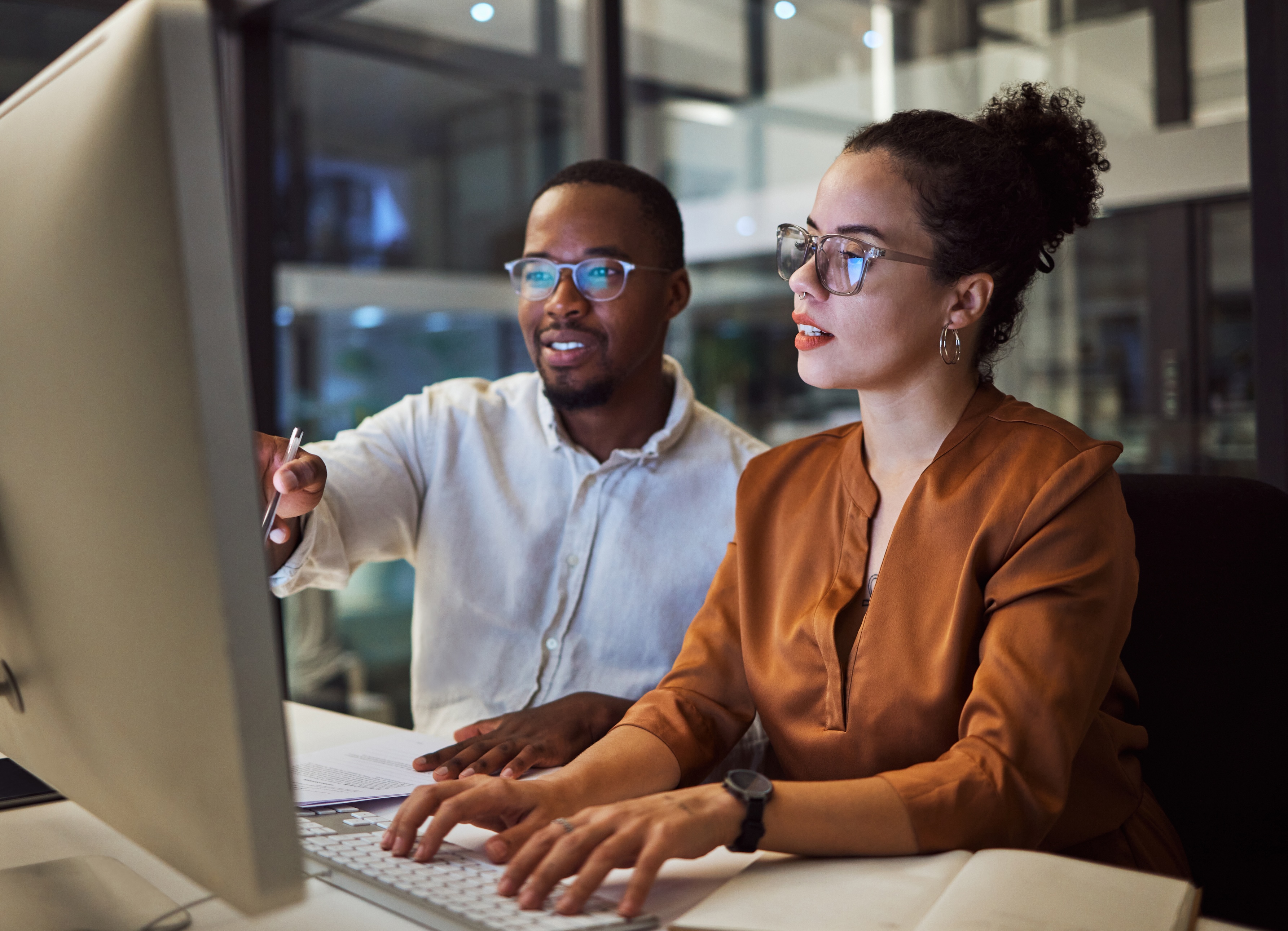 Man and woman collaborating at a computer, demonstrating how real human input enhances security decision-making and response