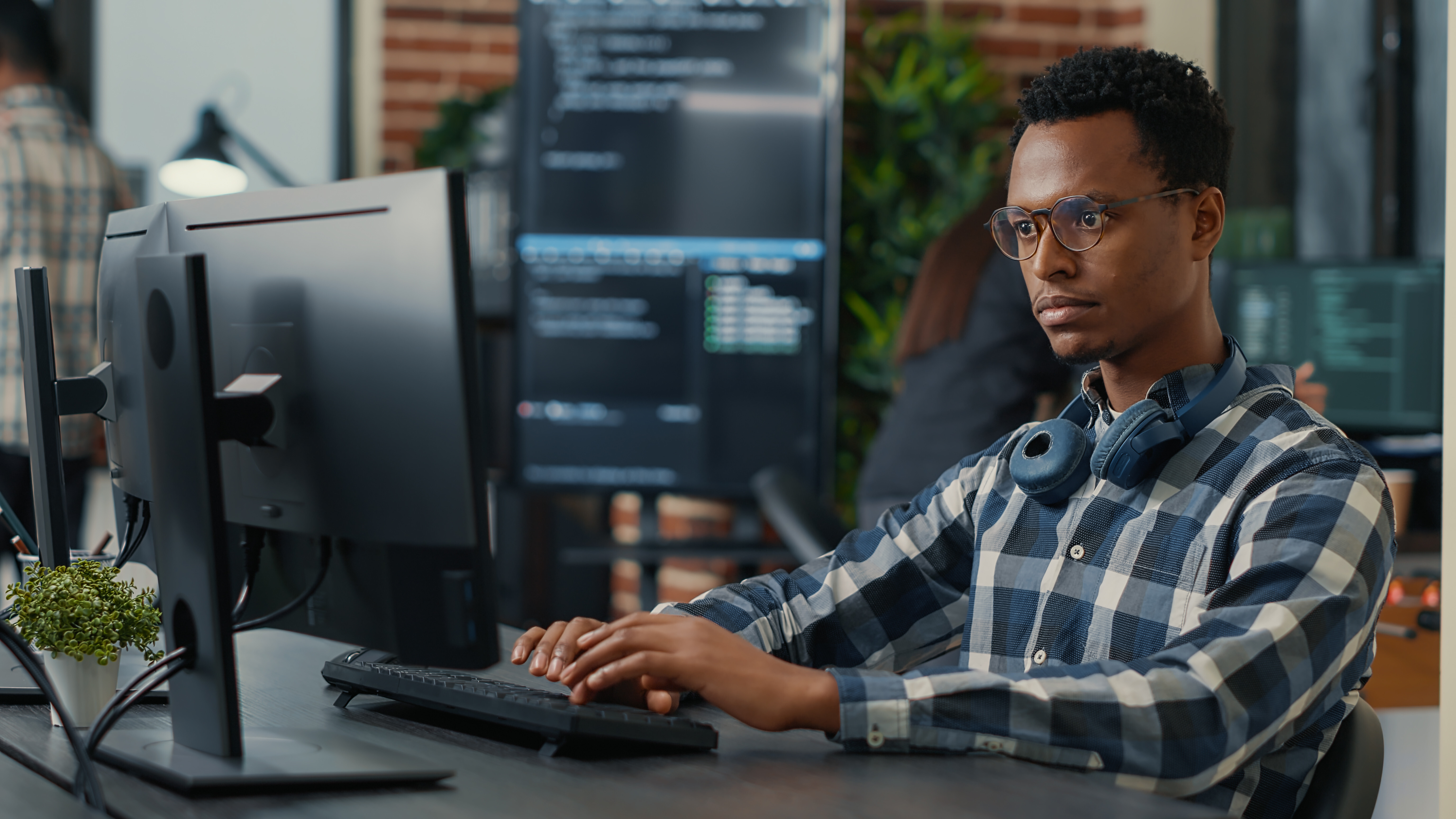 Man concentrating on his monitor, demonstrating how Crowdalert seamlessly integrates with tools like GitHub and AWS for enhanced security management