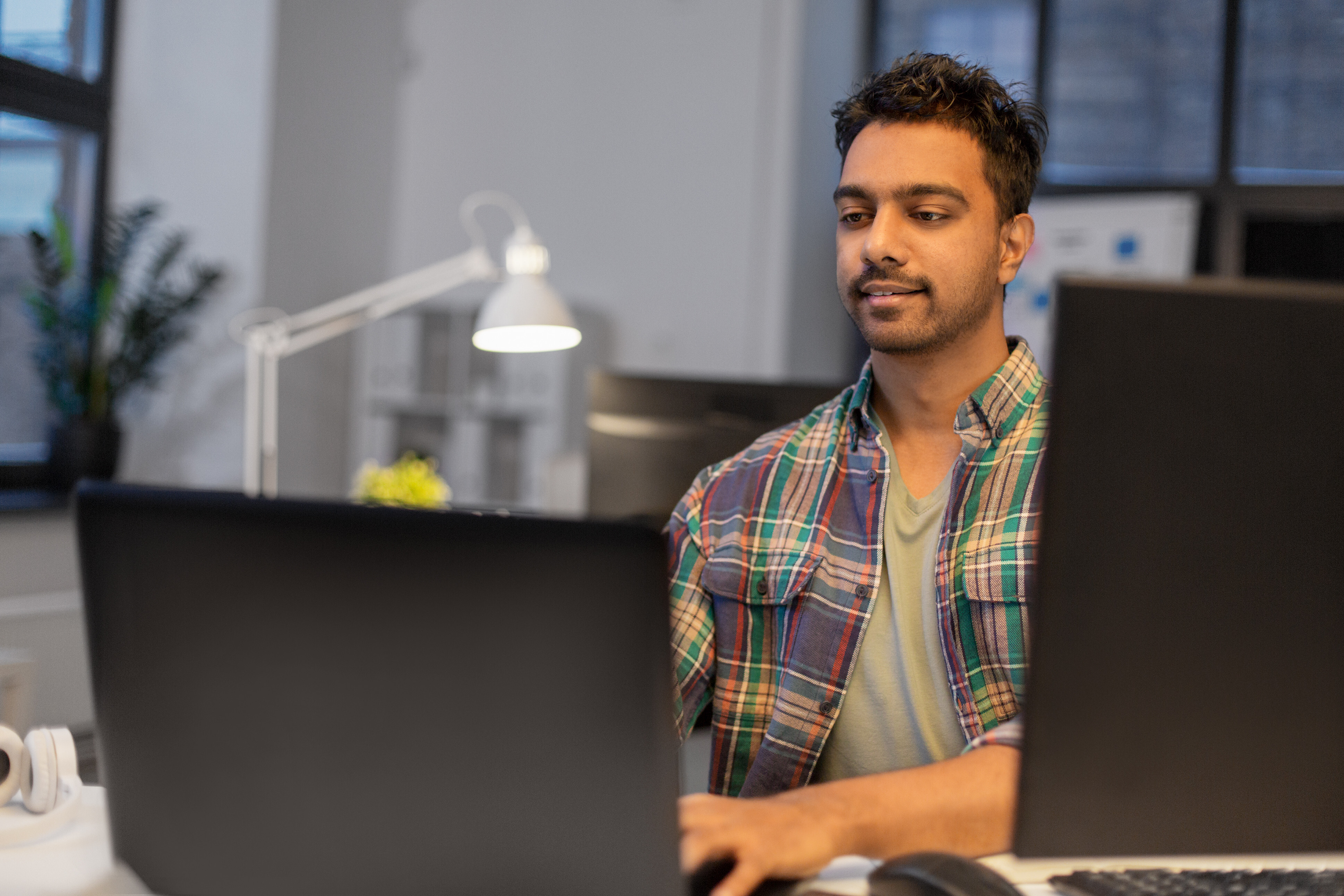 Man satisfied while working on his computer, demonstrating how Crowdalert helps identify recurring security issues before they escalate